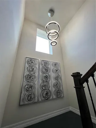 a living room with furniture a flat screen tv and gym equipment