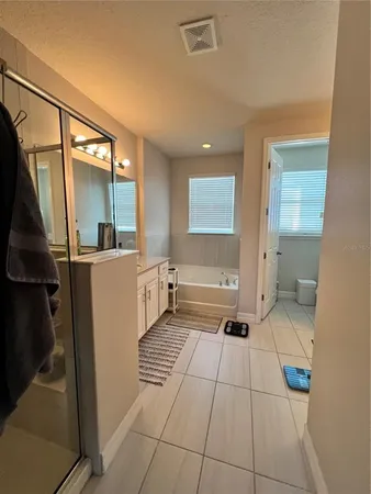 a large bathroom with a sink a mirror and a shower