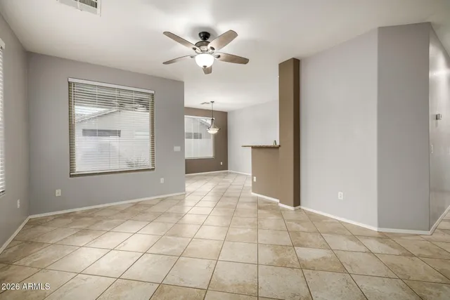 a view of an empty room with window and cabinet
