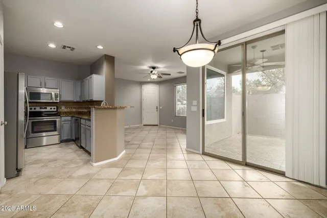 a view of a kitchen with a refrigerator and microwave