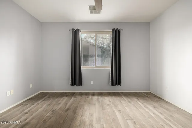 wooden floor and window in an empty room