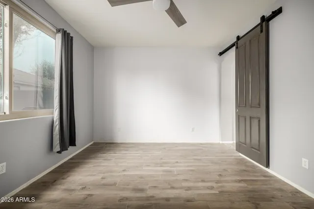 a view of room with window and hardwood floor