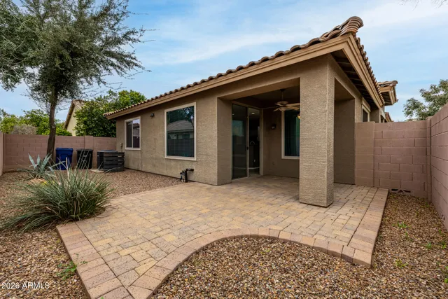 a view of a house with a yard and potted plants