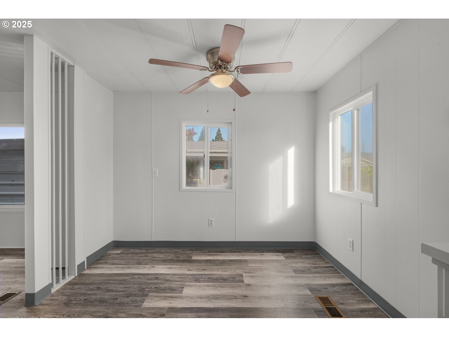 5355 River Road North, Unit 85 Keizer, OR 97303 - Photo 12 of 25 a view of empty room with wooden floor and fan