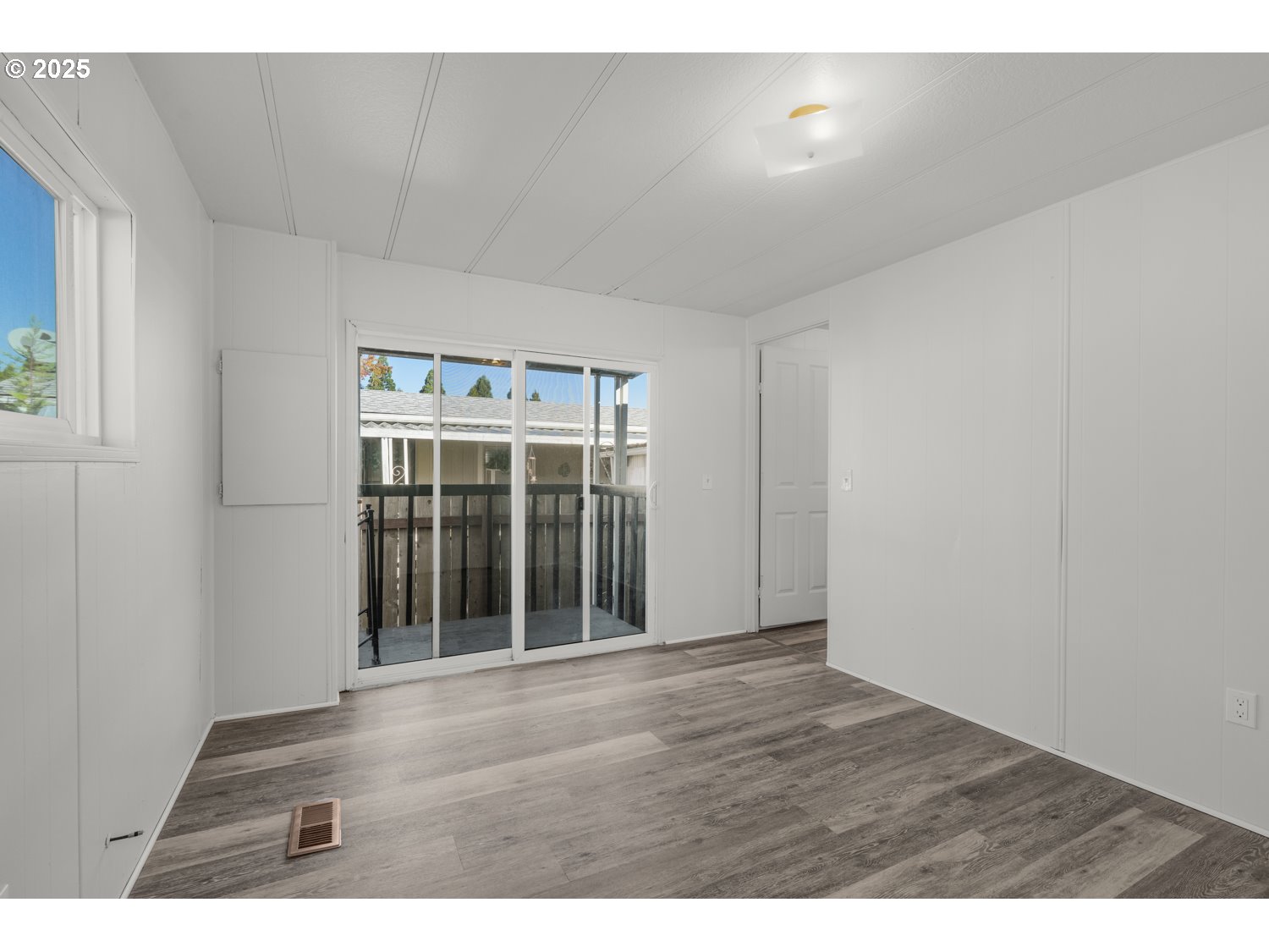 5355 River Road North, Unit 85 Keizer, OR 97303 - Photo 14 of 25 a view of an empty room with wooden floor and a window