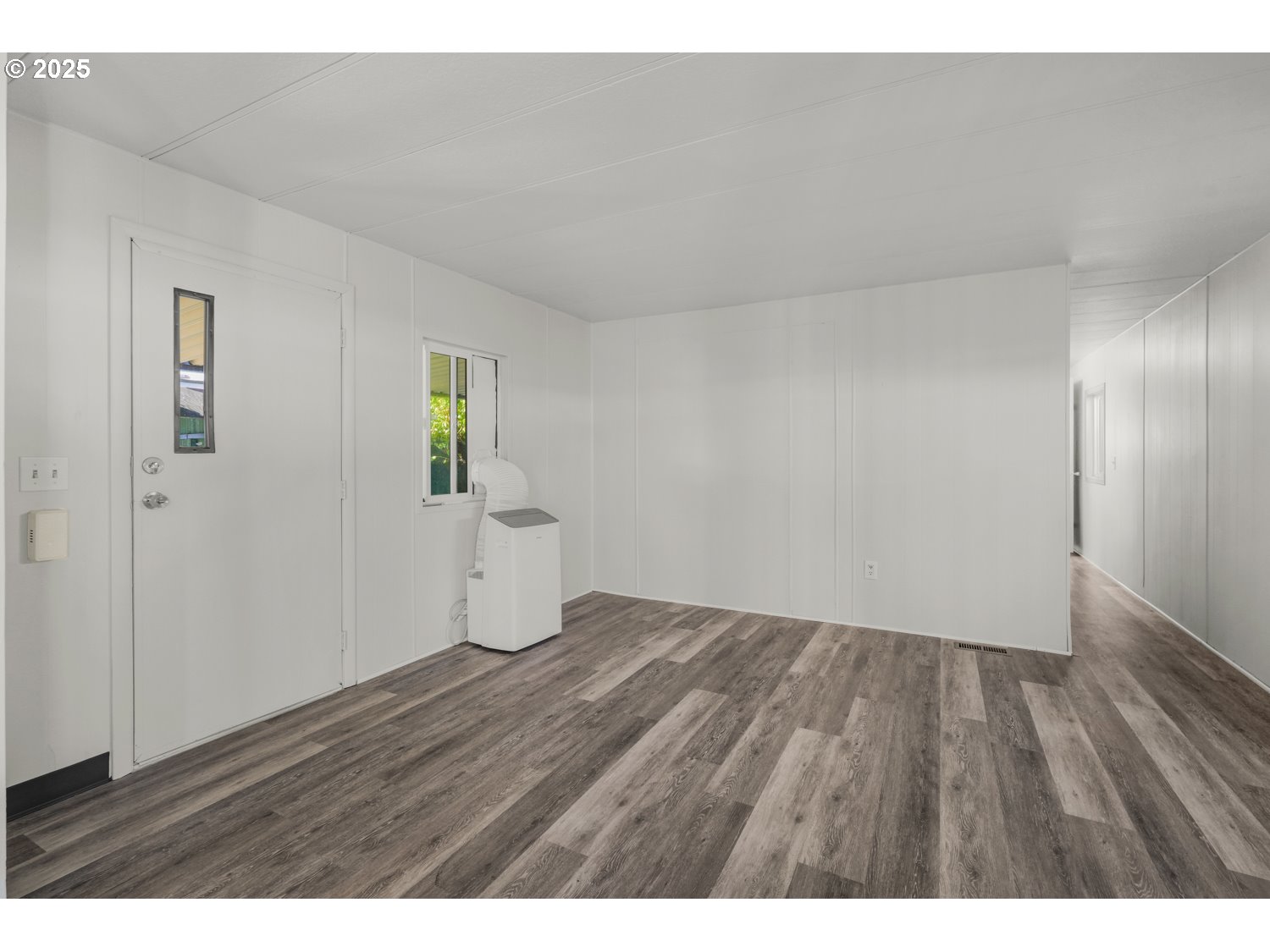 5355 River Road North, Unit 85 Keizer, OR 97303 - Photo 3 of 25 a view of an empty room and wooden floor