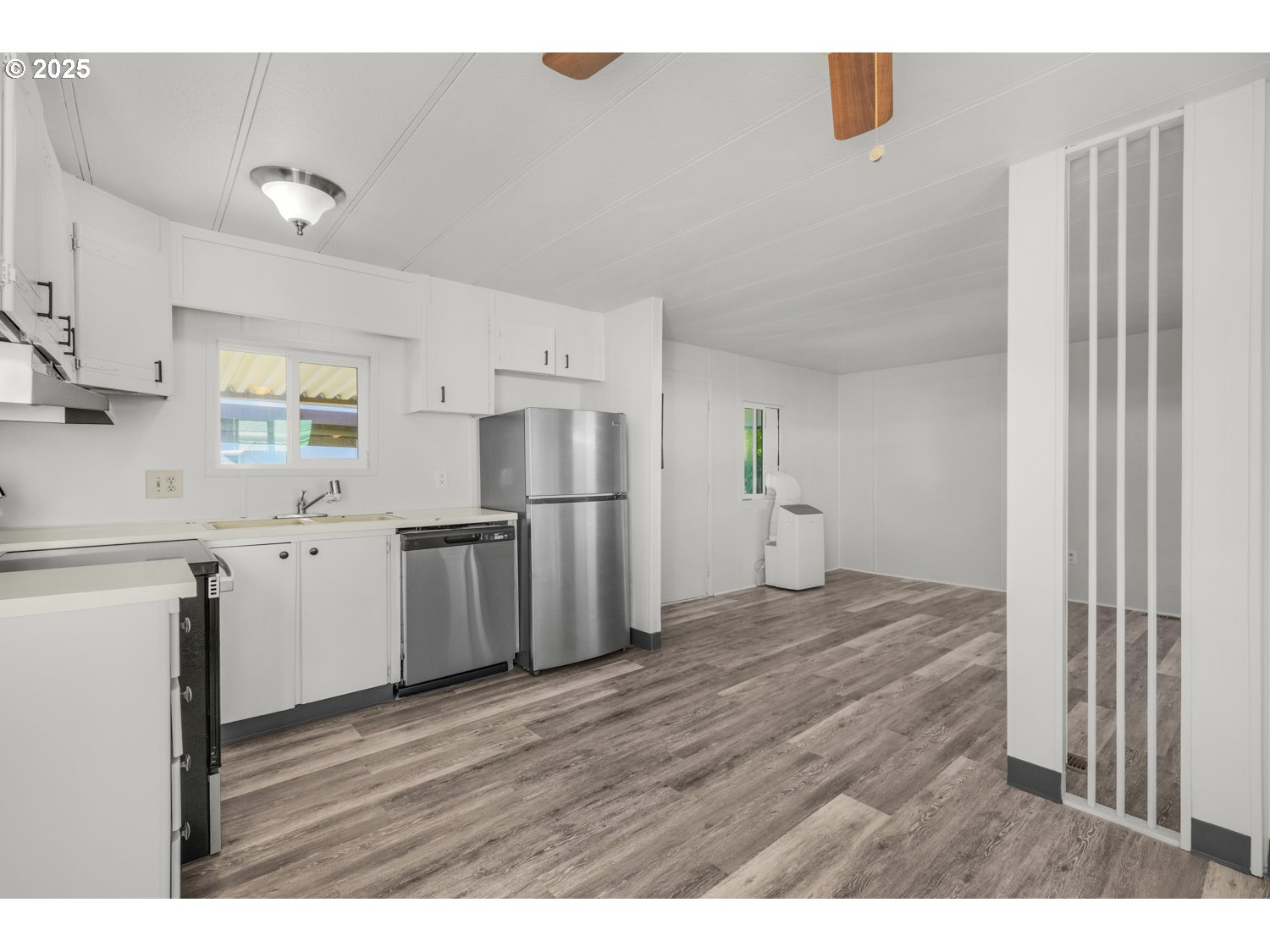 5355 River Road North, Unit 85 Keizer, OR 97303 - Photo 10 of 25 a view of a kitchen with wooden floor and electronic appliances