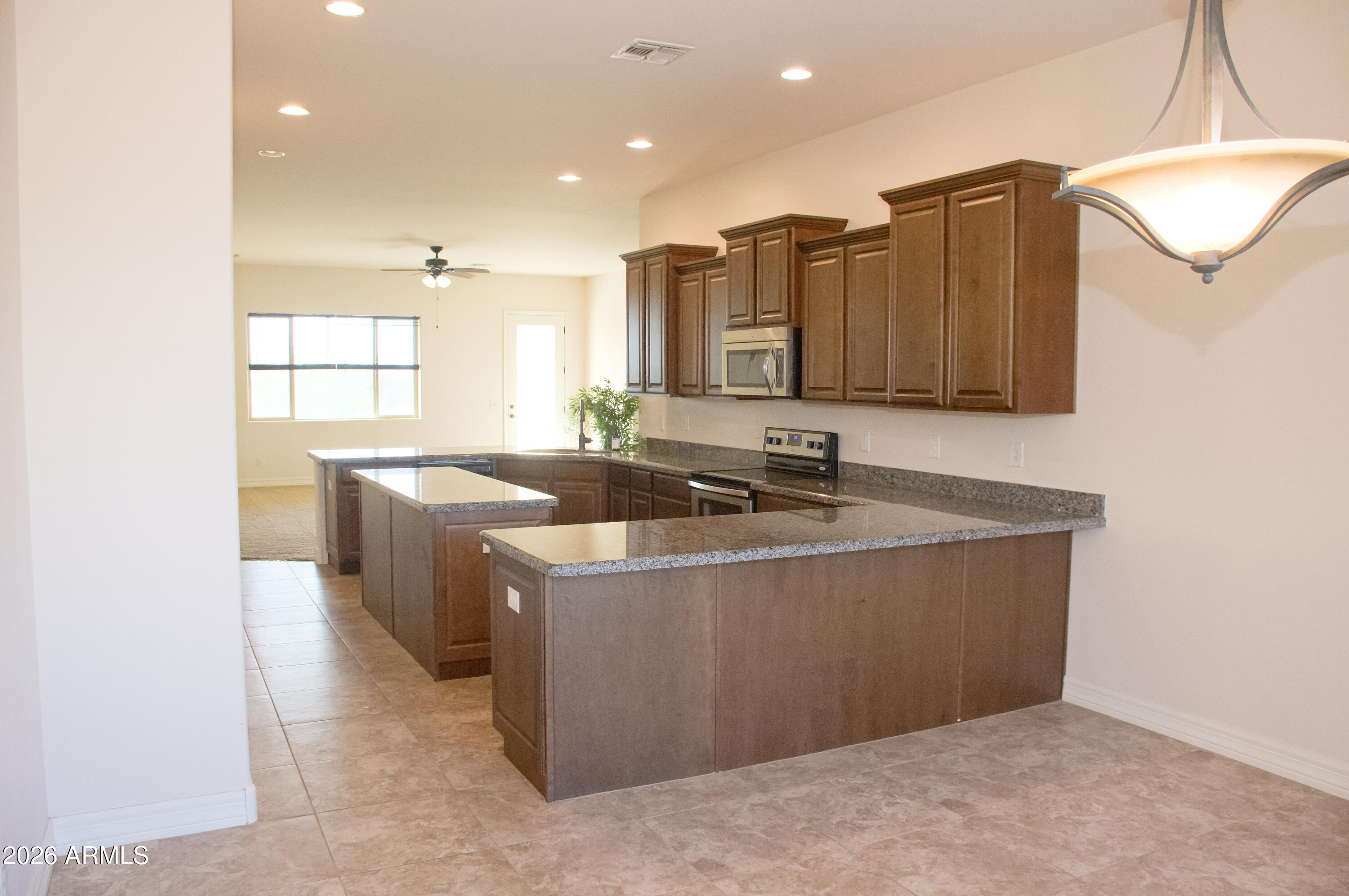 1623 East Hidalgo Street Apache Junction, AZ 85119 - Photo 13 of 65 a kitchen with stainless steel appliances granite countertop a sink and a refrigerator