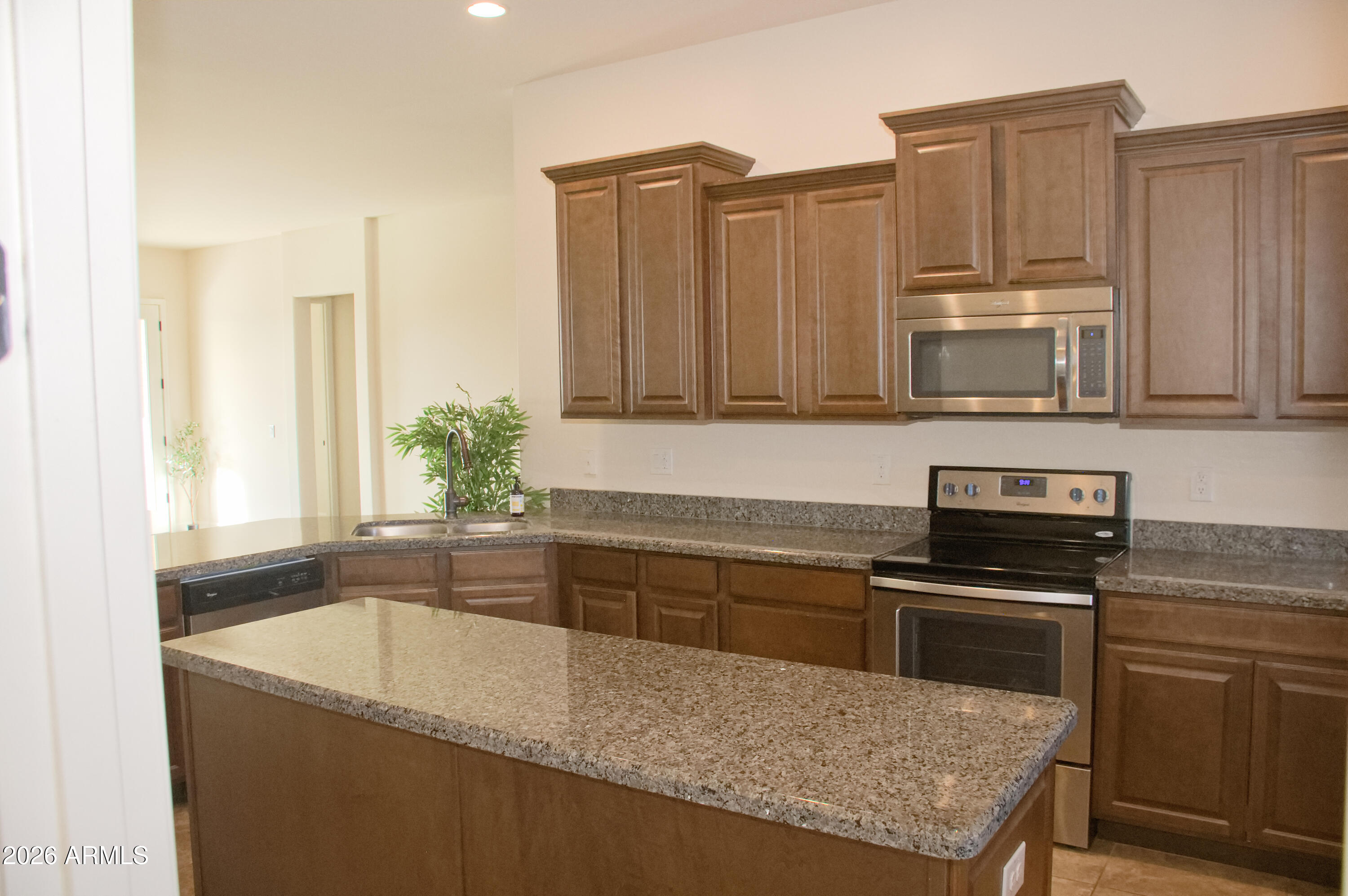 1623 East Hidalgo Street Apache Junction, AZ 85119 - Photo 14 of 65 a kitchen with stainless steel appliances granite countertop a stove a sink and a microwave