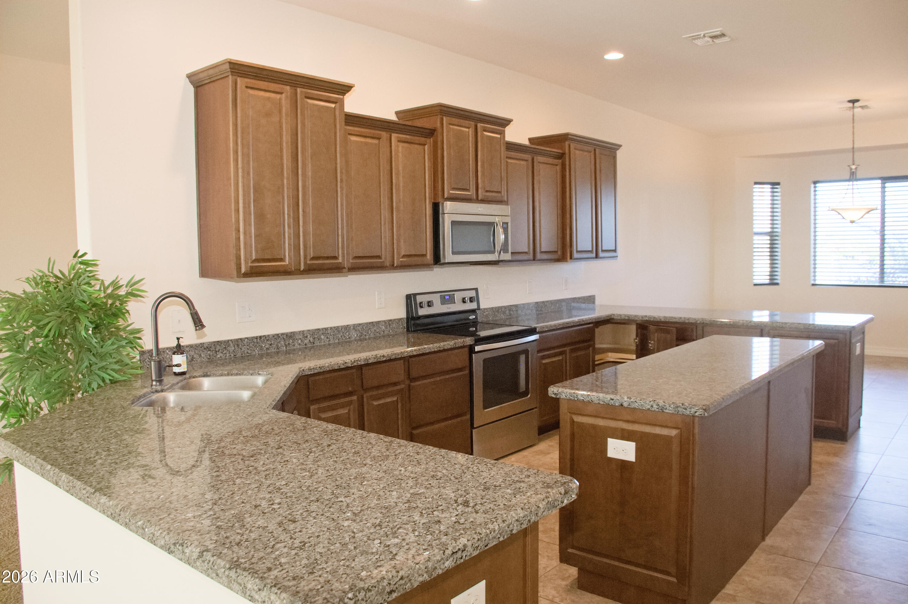1623 East Hidalgo Street Apache Junction, AZ 85119 - Photo 16 of 65 a kitchen with stainless steel appliances granite countertop a sink stove and refrigerator