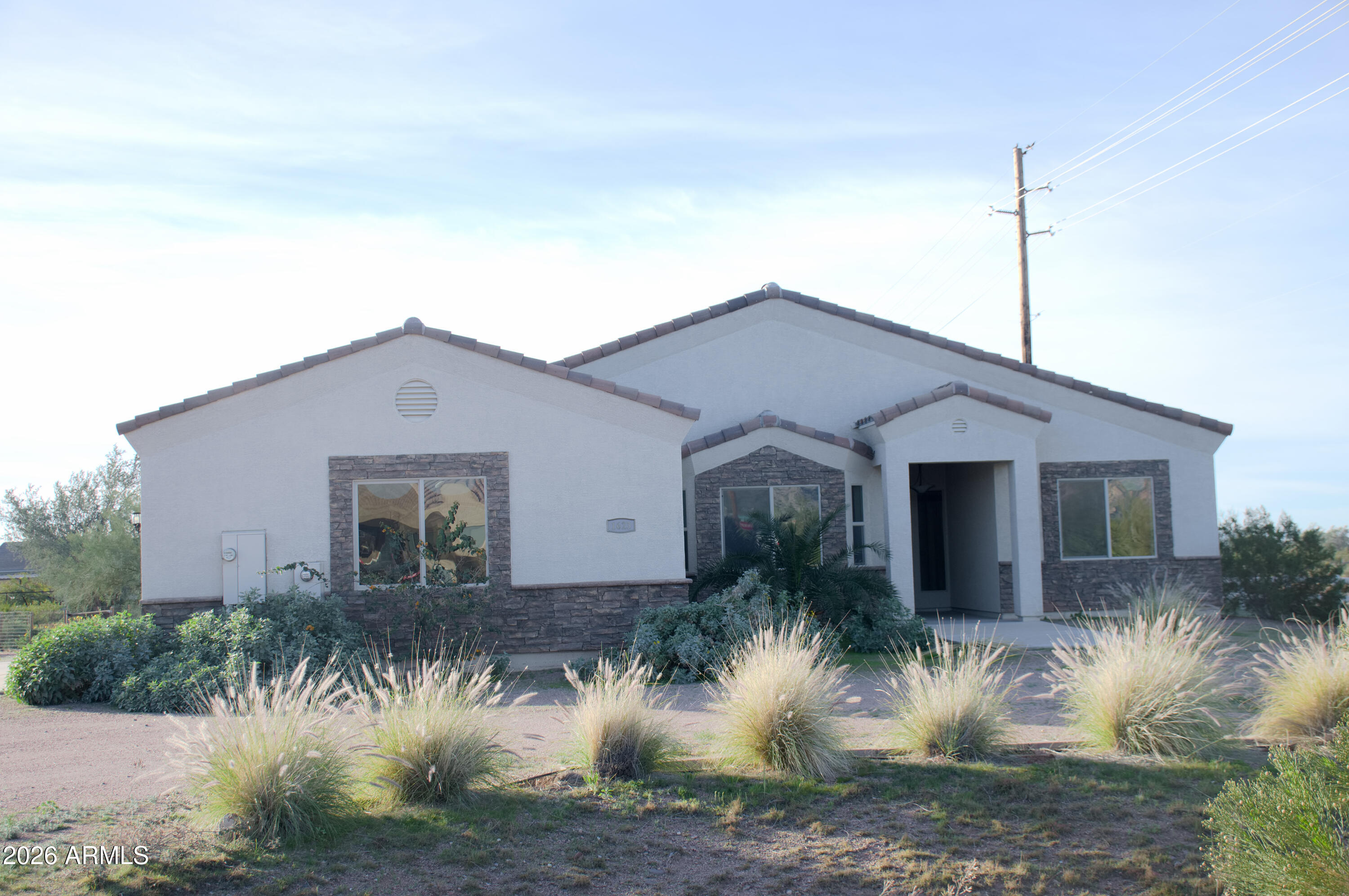 1623 East Hidalgo Street Apache Junction, AZ 85119 - Photo 2 of 65 a front view of house with a yard and potted plants