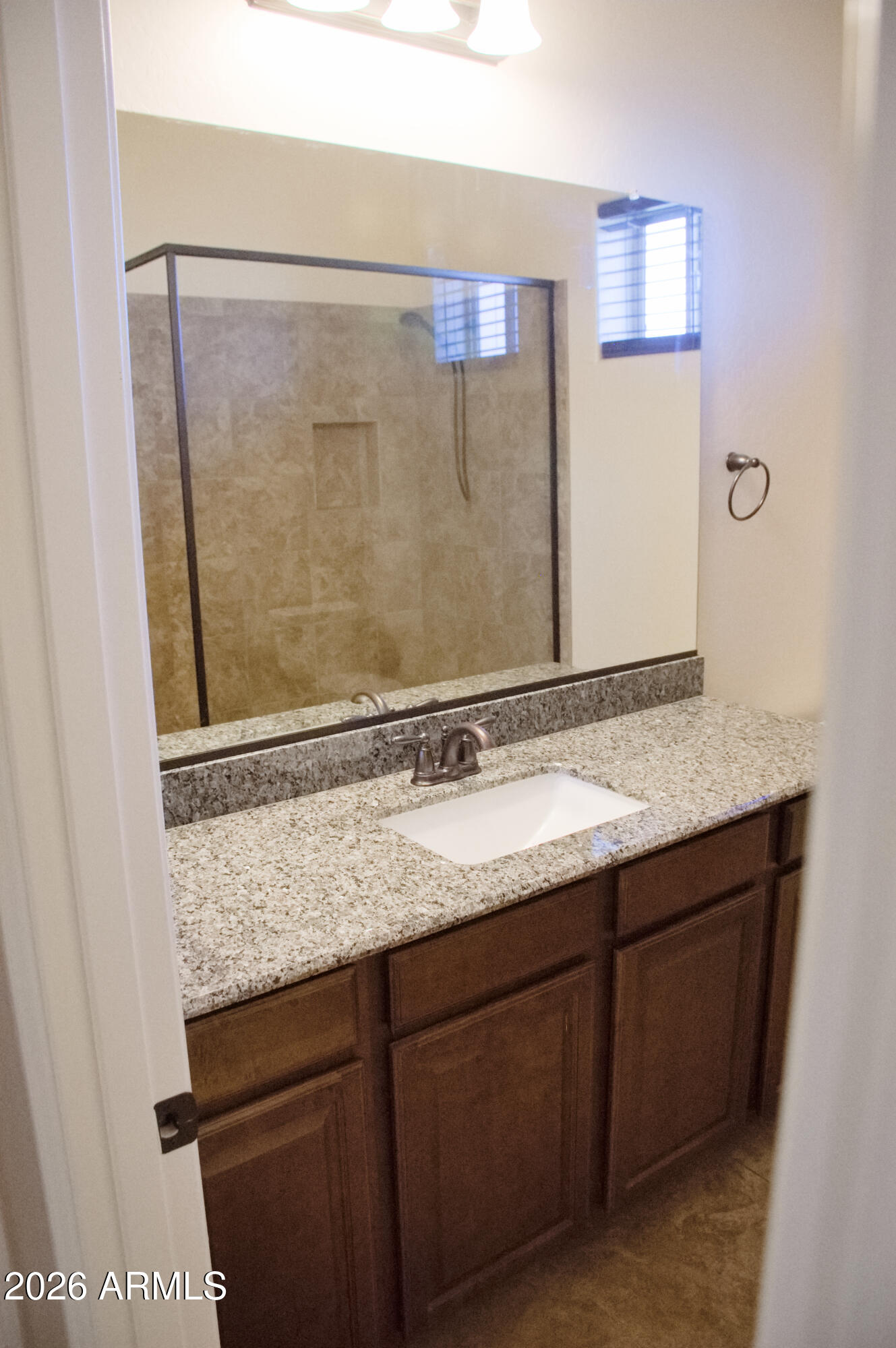 1623 East Hidalgo Street Apache Junction, AZ 85119 - Photo 30 of 65 a bathroom with a granite countertop sink and a mirror