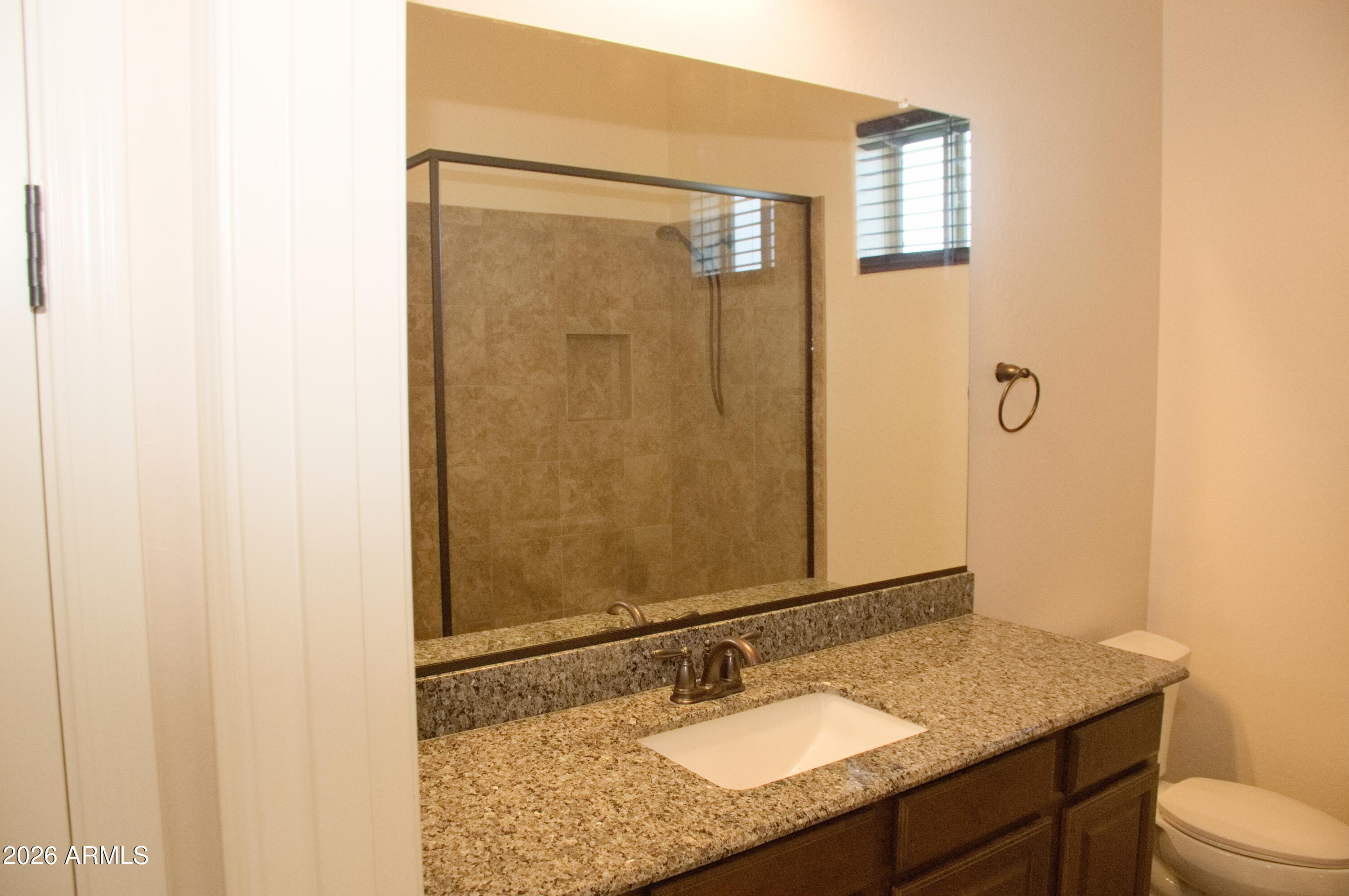 1623 East Hidalgo Street Apache Junction, AZ 85119 - Photo 31 of 65 a bathroom with a granite countertop sink toilet and shower