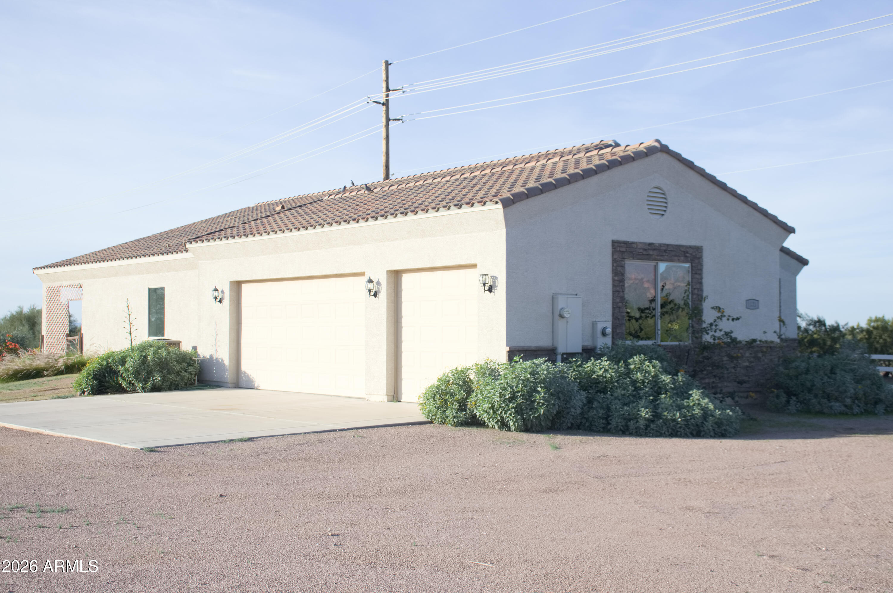 1623 East Hidalgo Street Apache Junction, AZ 85119 - Photo 34 of 65 a front view of a house with a yard and garage
