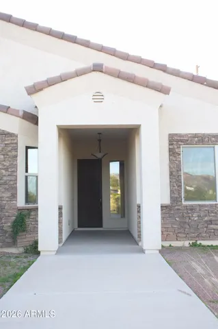 a view of a hallway with potted plants
