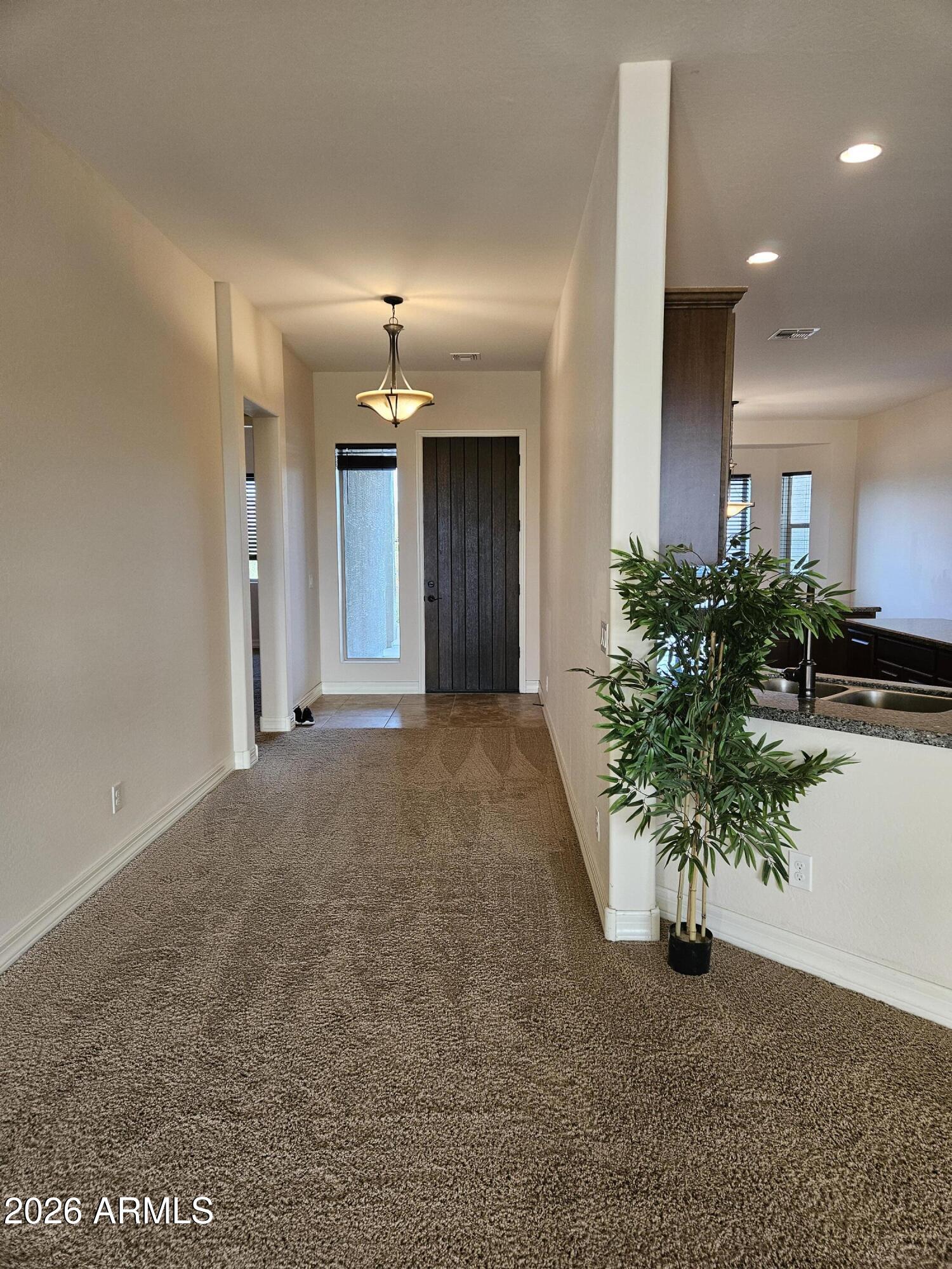 1623 East Hidalgo Street Apache Junction, AZ 85119 - Photo 5 of 65 a view of a hallway with potted plants