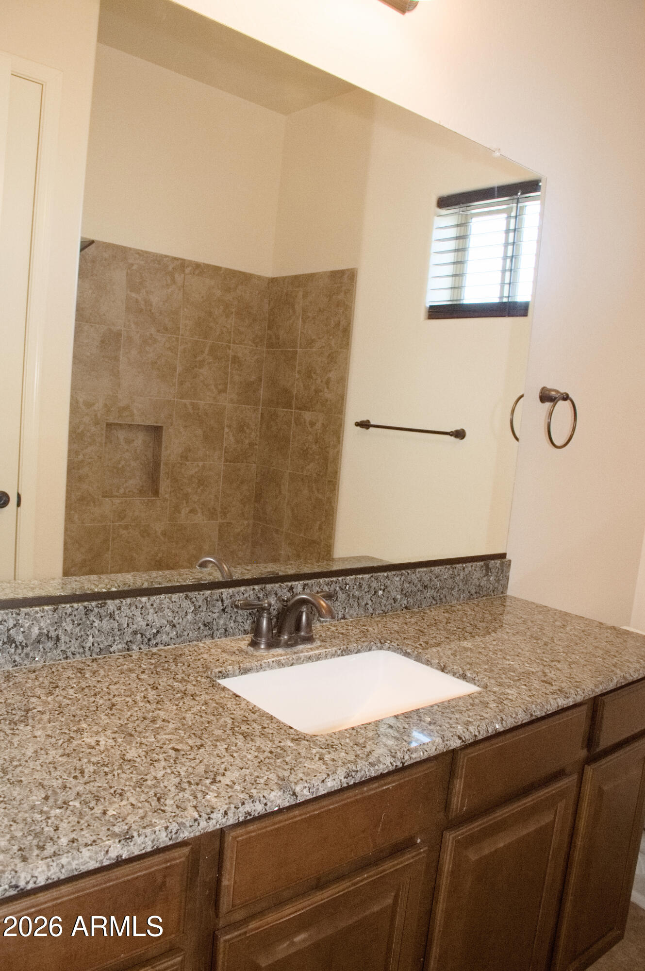 1623 East Hidalgo Street Apache Junction, AZ 85119 - Photo 52 of 65 a bathroom with a granite countertop sink and a mirror