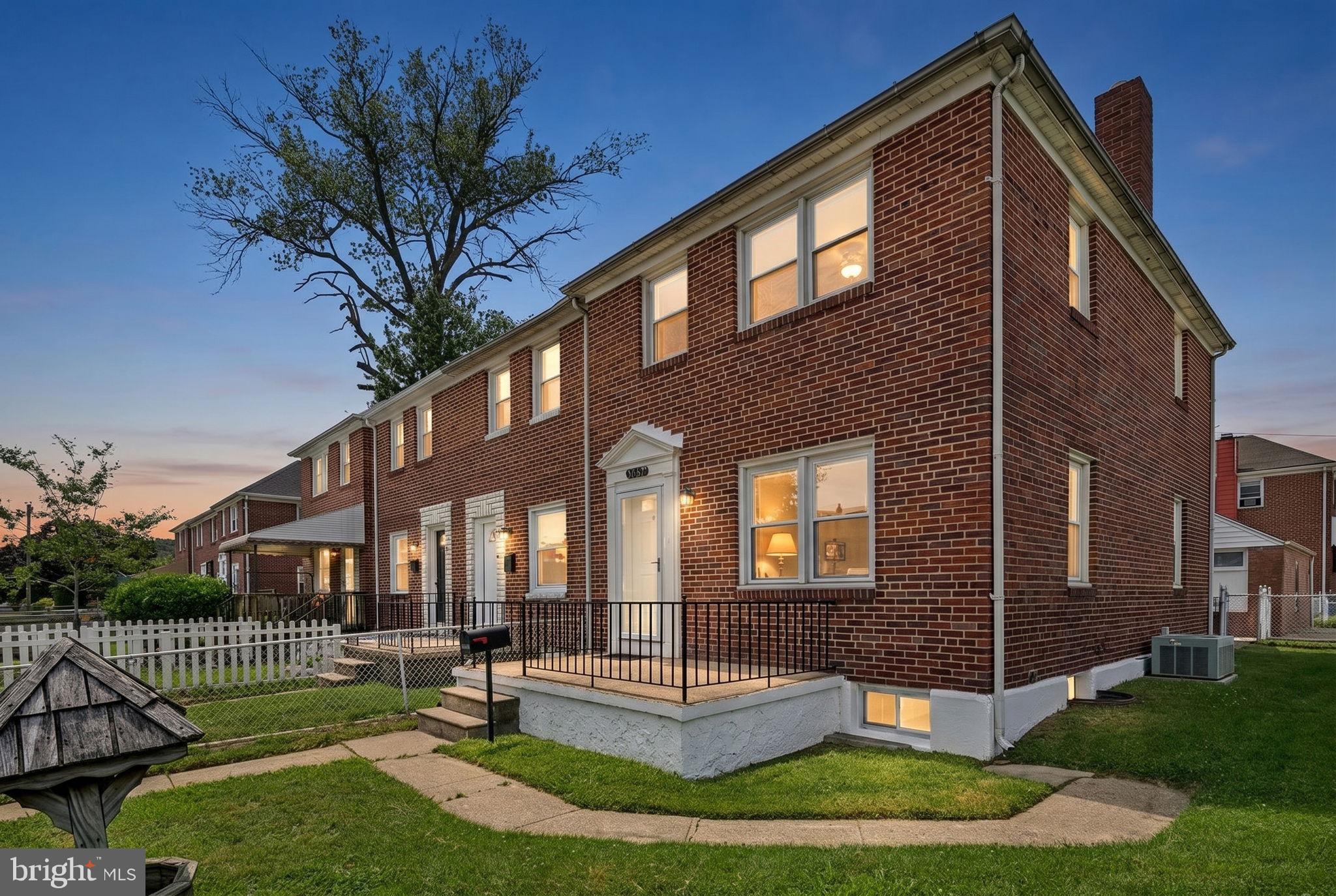 Charming brick home at twilight.
