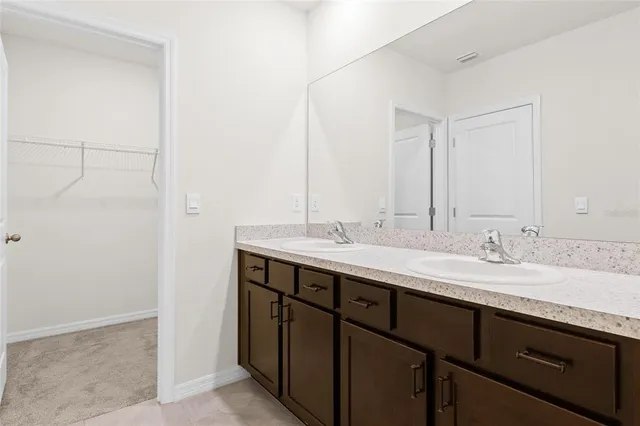 a bathroom with a double vanity sink and a mirror