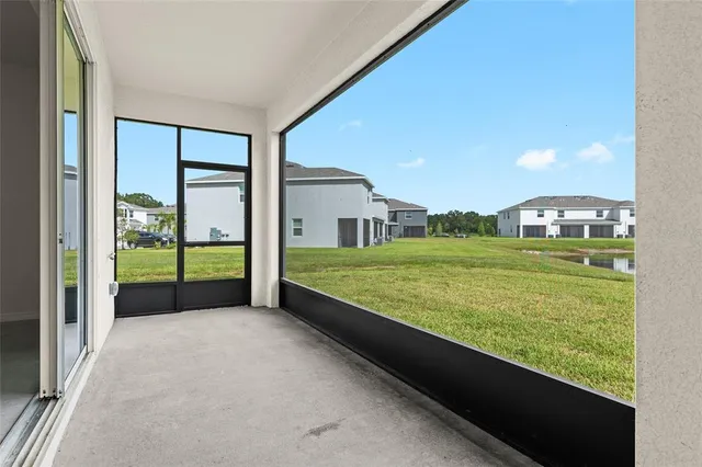 a large house with a big yard and large trees