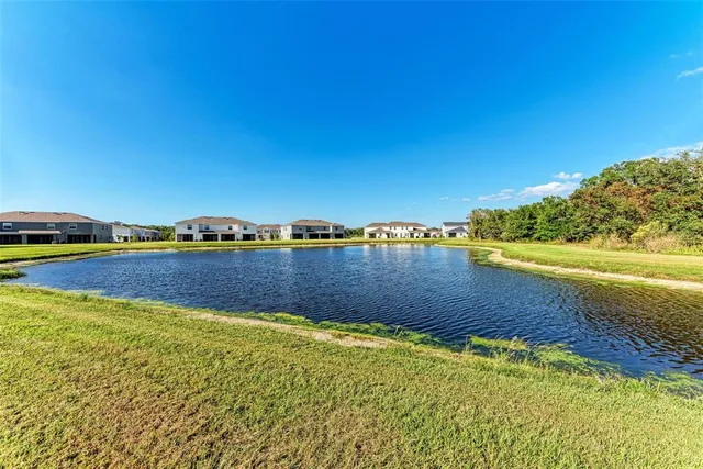a view of a lake with houses in the background