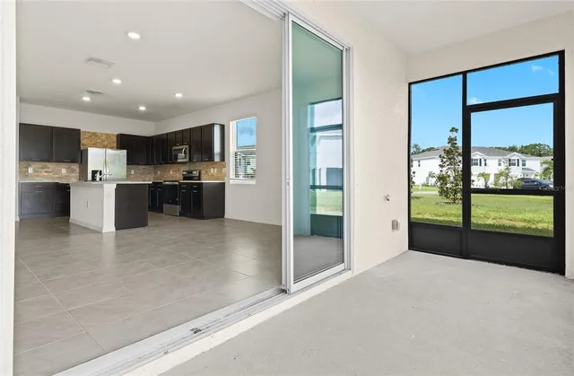 a open kitchen with stainless steel appliances granite countertop a refrigerator and a stove top oven