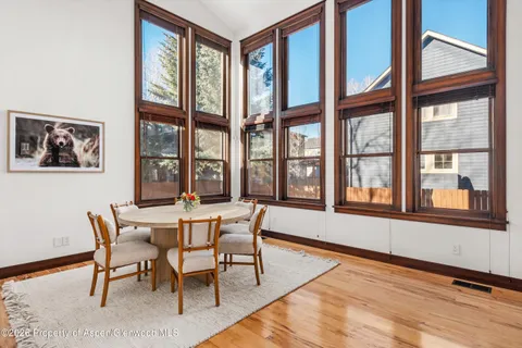 a dining room with furniture a rug and a large window