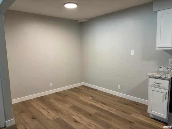 a view of a room with wooden floor and sink