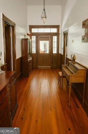 a living room with hard wood floors and a bed
