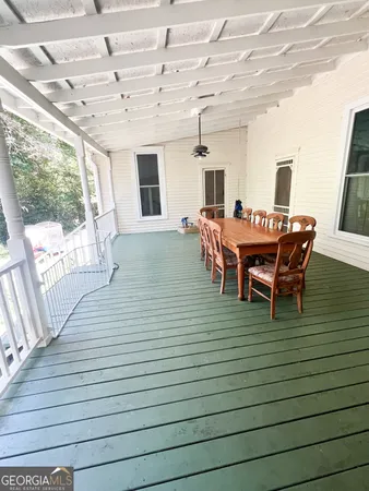 a dining room with furniture and wooden floor