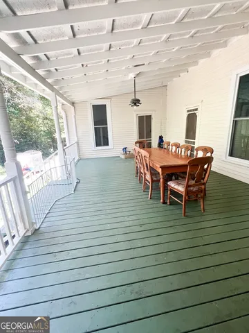 a dining room with furniture and wooden floor