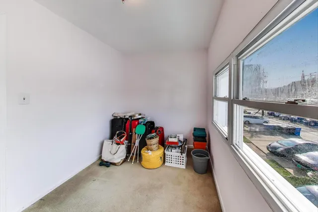 a view of a room with gym equipment and windows