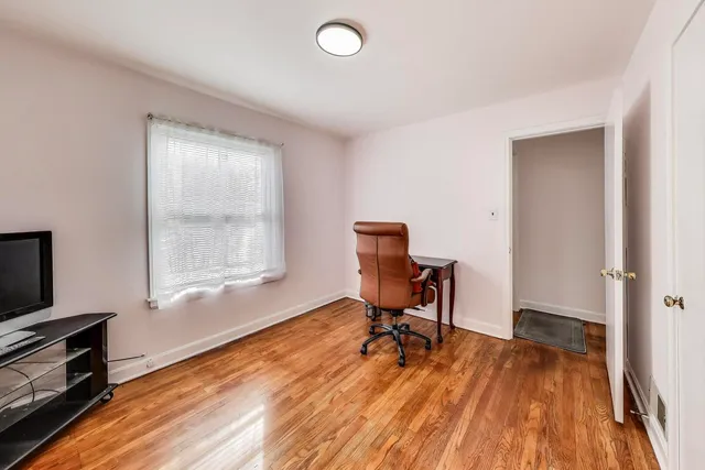 a view of a workspace with furniture and a window