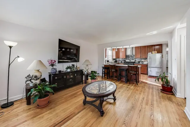 a living room with furniture a piano and wooden floor