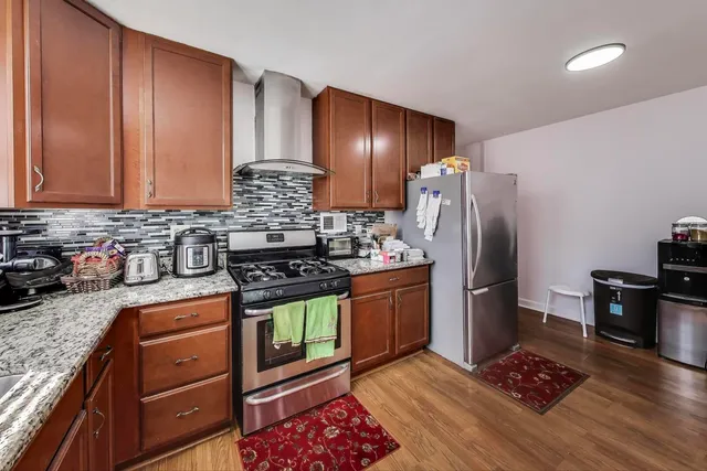 a kitchen with stainless steel appliances granite countertop a refrigerator stove microwave and sink