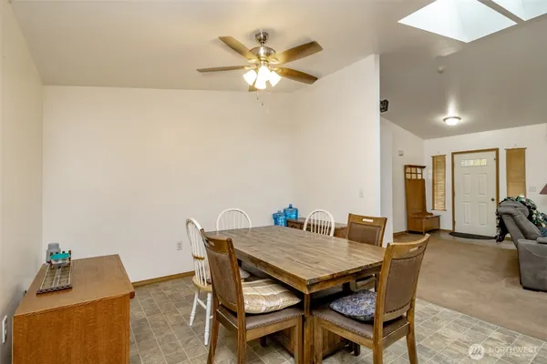a view of a dining room with furniture and a chandelier