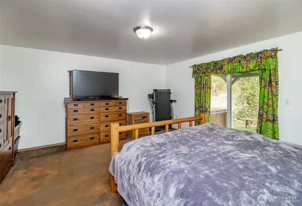 a bedroom with furniture and a window