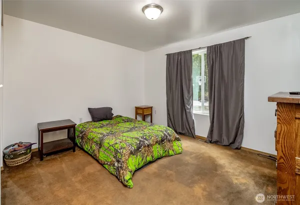 a bathroom with a granite countertop sink mirror vanity and toilet