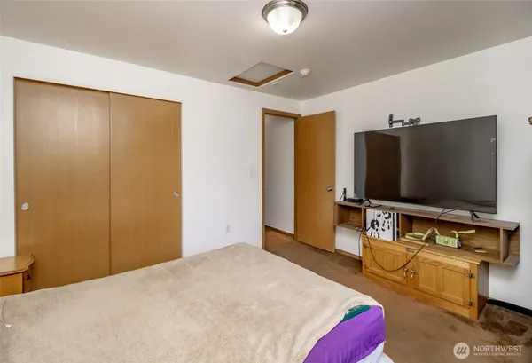 a bedroom with a bed and window