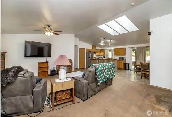a living room with furniture and a chandelier