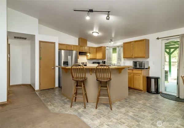 a kitchen with a sink appliances and cabinets