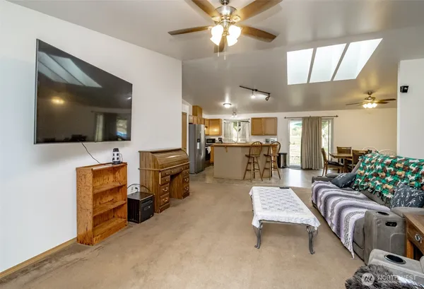 a living room with furniture and a chandelier