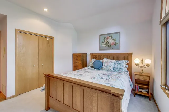 a bedroom with a bed and a painting on the wall