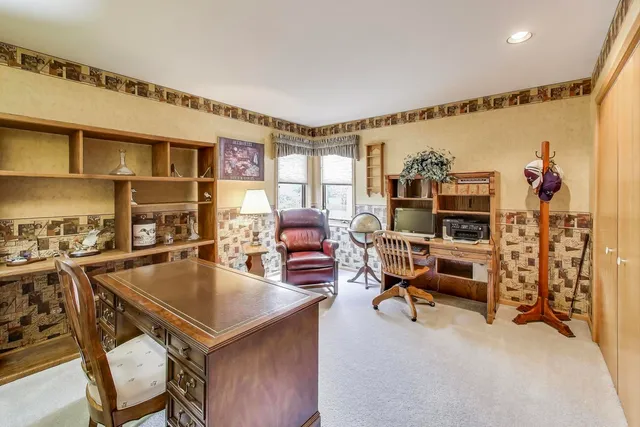a living room with furniture a flat screen tv and a table