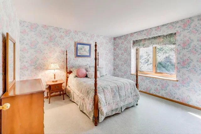 a bedroom with a bed and window