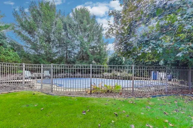 a view of a yard with wooden fence