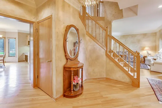 a view of entryway and hall with wooden floor