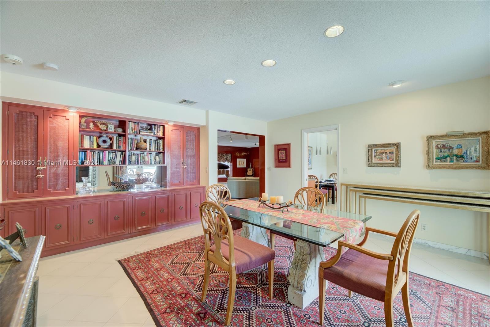 4300 Casper Court Hollywood, FL 33021 - Photo 11 of 24 a dining room with furniture a rug and wooden floor