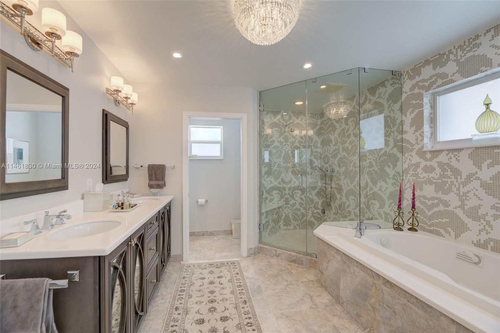 4300 Casper Court Hollywood, FL 33021 - Photo 13 of 24 a spacious bathroom with a double vanity sink a mirror and a bathtub