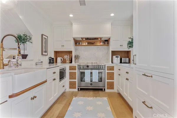 a living room with furniture a flat screen tv and a floor to ceiling window